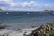 Local fishing boats anchored off rocky shore