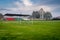 Local football stadium with small sports tribune seen through the goal. Trees in the background. Autumn day in the countryside