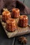 Local French dessert canele on a wooden board