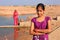 Local girl standing near water reservoir, Khichan village, India