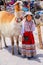 Local girl in traditional dress standing at the market in Maca v