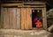 Local Hmong hill tribe woman uses sewing machine while her daughter poses for photo