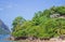 Local hut on seacoast. Traditional cabin in tropical jungle near the sea. Tropical landscape with rural bungalow.