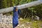 A local kid carrying metal roof sheets