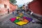 Local kids are creating alfombre flower carpets on the cobbled streets of Antigua, Guatemala