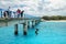 Local kids jumping off the Mouli Bridge between Ouvea and Mouli islands, Loyalty Islands, New Caledonia