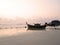Local long tail boat in sea at sunrise when tide is falling or going out. Peaceful feeling at Lipe Island, Satun, Thailand