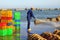 A local man is cleaning his baskets which were used for transporting fishes from the boat to the truck