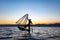 Local man fishing with a net at sunset, Amarapura, Mandalay region, Myanmar.