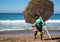 A local man walks down the beach on the Pacific Ocean