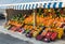 Local neighborhood fresh organic fruit market counters with fresh colorful fruits on display in greece