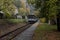 A local passenger train arriving at a train station near a small village