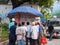 Local residents read newspapers on a stand in the city center