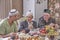 Local residents of Siberian village celebrate Muslim holiday Kurban Bayram at their home table. Mullah talking with