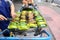 Local seller make Thai roasted sweet sticky rice in banana leaf at Sanam Pao, Bangkok, Thailand