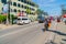 Local seller takes coconuts on bicycle. Street resort on sunny summer day