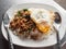 Local Thai rice topped with stir-fried pork basil and fried egg.