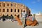 A local tunisian posing with his camel in front of the impressive Roman amphitheater of El Jem