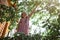 Local vacation at the farm. Girl picking cherry from the fruit tree standing on stepladder, lifestyle