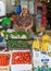 Local vendor selling fresh fruits and vegetables in a stall at Osh market, Kyrgyzstan