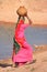 Local woman carrying jar with water on her head, Khichan village