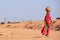 Local woman carrying jar with water on her head, Khichan village