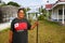 Local woman cleaning church yard, Ofu island, Tonga