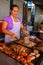 Local woman cooking meat for asado at Mercado 4 in Asuncion, Par