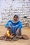 Local woman making fire using dry cow dung in Taj Ganj neighborhood of Agra, Uttar Pradesh, India