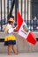 Local woman standing with a flag during Festival of the Virgin d