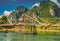 A local woman with a sun umbrella crosses a bamboo bridge in Vang Vieng, Laos