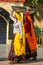 Local women carrying metal buckets on their heads in Agra, Uttar Pradesh, India