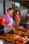 Local women cooking meat for asado at Mercado 4 in Asuncion, Par