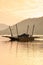 Local wooden ferry boat on peaceful lake at sunset