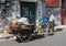 Local worker collects cardboard for recycling with bicycle