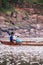 Local Young Thai fisherman and fishing net on boat in Mekong river