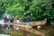 Locals papuan from citak-mitak tribe in the traditional papuan pirogue from a tree trunk