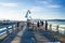 Locals and Tourists strolling along a Fishing Pier at Sunset