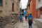 Locals and tourists walk along a narrow alley through the old town. Hike in the closed area of the upper Mustang. Nepal