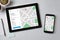 Location tracker concept on tablet and smartphone screen. GPS ma