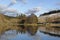 Loch Saugh in Winter with reflections in the calm water and some snow on the hillsides.