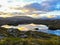 Loch at sunset with clouds reflecting on the water