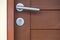 Lock and door handle on solid wooden door