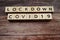 Lock down Covid-19 alphabet letters on wooden background