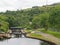 Lock gates on the calder hand hebble navigation canal in front of the basin in sowerby bridge west yorkshire surrounded by