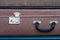 Lock and handle on old suitcase. Close up.