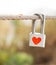 Lock with heart symbol on rope bridge as a promise of lover