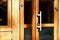 Lock and key. Modern wooden door with a convenient large handle and lock. Entrance to the building, cafe, home, restaurant