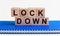Lockdown, word cube with blue background. Business concept