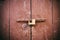 Locked door. Closed old rusty padlock on an old brown wooden door